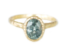 oval teal sapphire ring in textured gold