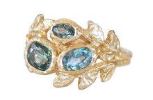 Custom golden leaves ring with three teal and green oval sapphires