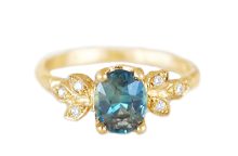 Oval teal sapphire ring with golden leaves and diamonds